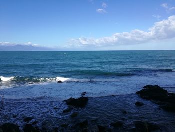 Scenic view of sea against blue sky