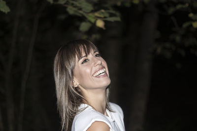 Beautiful woman laughing in the field with white shirt