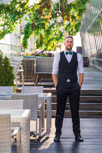 Portrait of young man standing in city