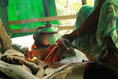 Midsection of woman holding wood