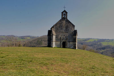 Built structure on field against sky