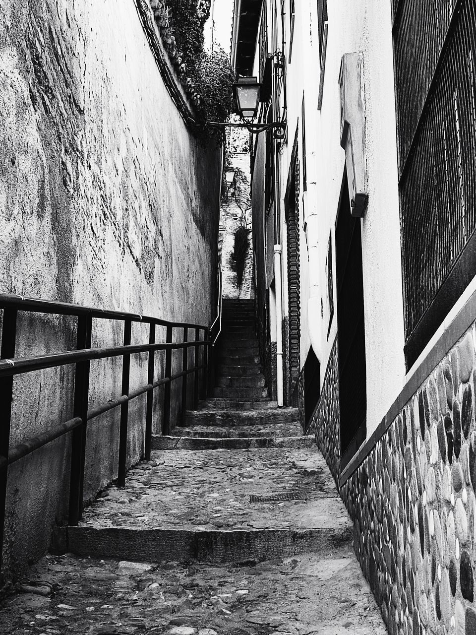 architecture, built structure, street, road, alley, black, the way forward, white, black and white, monochrome, building exterior, monochrome photography, railing, wall - building feature, day, staircase, infrastructure, building, urban area, no people, steps and staircases, footpath, narrow, wall, lane, outdoors, diminishing perspective, nature, city, darkness, sunlight