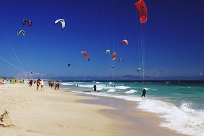 People on beach against sky