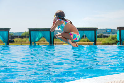 Young woman swimming in pool