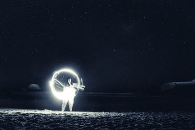 Light painting against sky at night