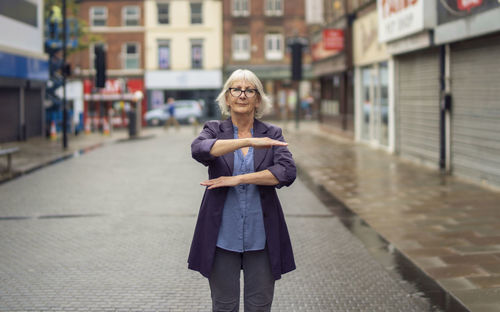 Portrait of woman standing in city