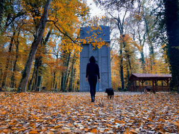 Rear view of woman walking on field