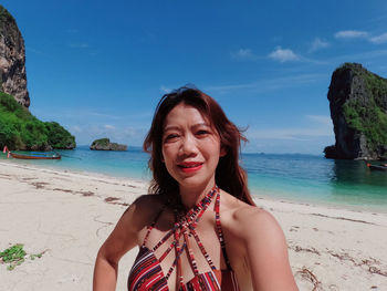 Portrait of young woman standing at beach against sky ko poda mu ko phi phi 