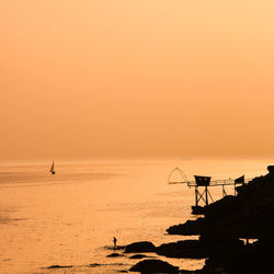 Scenic view of sea against orange sky