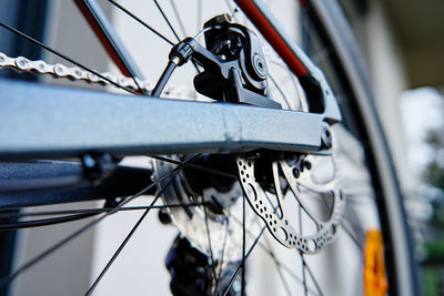 Part of the bicycle's braking system. grey metal brake disc and brake pads on road bike, close up.