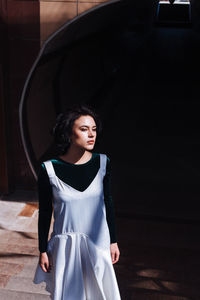 Fashionable woman standing outdoors during sunny day