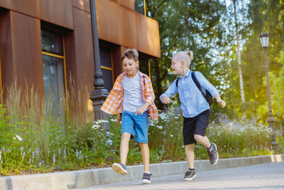 Full length of woman walking on footpath