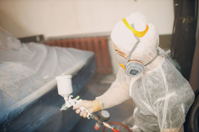 Portrait of woman holding equipment