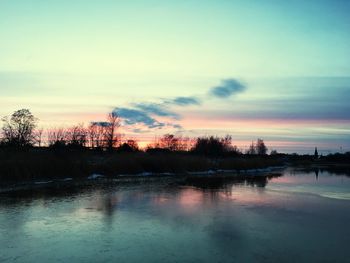 Scenic view of lake against sky during sunset