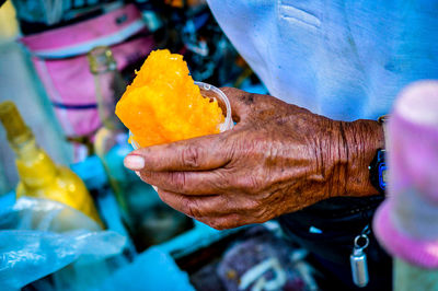 Close-up of hand holding ice cream at market