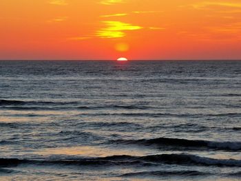 Scenic view of sea against romantic sky at sunset