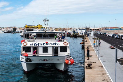 Boats moored on sea against sky