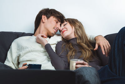 Side view of senior couple sitting on sofa at home