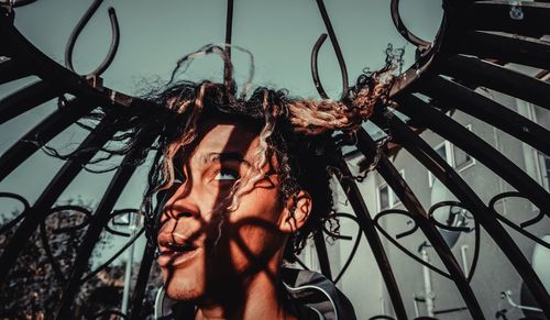 Low angle portrait of woman against sky