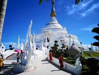 Panoramic view of buildings against blue sky