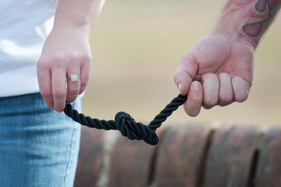 Close-up of hand holding rope