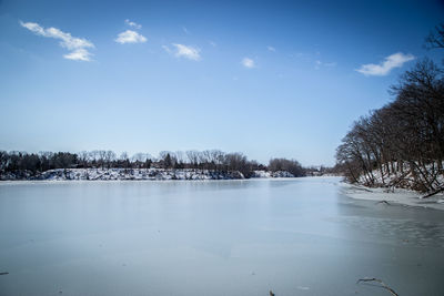 Scenic view of lake against sky during winter