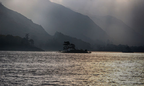 Scenic view of lake and mountains against sky