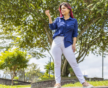 Full length of a smiling young woman in park