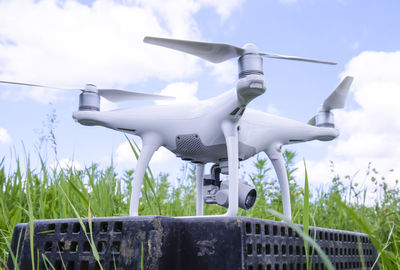 Close-up of camera on field against sky