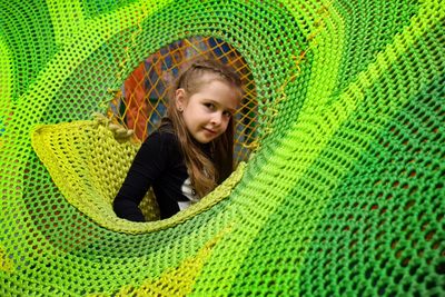 Portrait of smiling girl playing in jungle gym