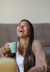 Portrait of young woman drinking coffee