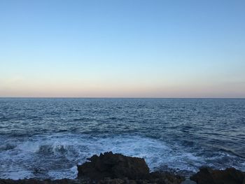 Scenic view of sea against clear blue sky