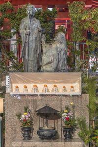 Buddha statue in front of cemetery