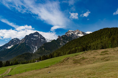 Scenic view of mountains against blue sky