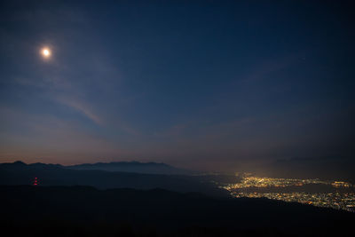 Silhouette mountains against sky at night