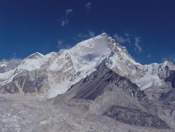 Scenic view of snowcapped mountains against blue sky