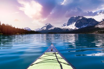 Scenic view of lake by mountains against sky