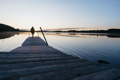 Silhouette of person at jetty