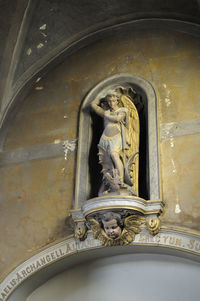 Statue of buddha against building