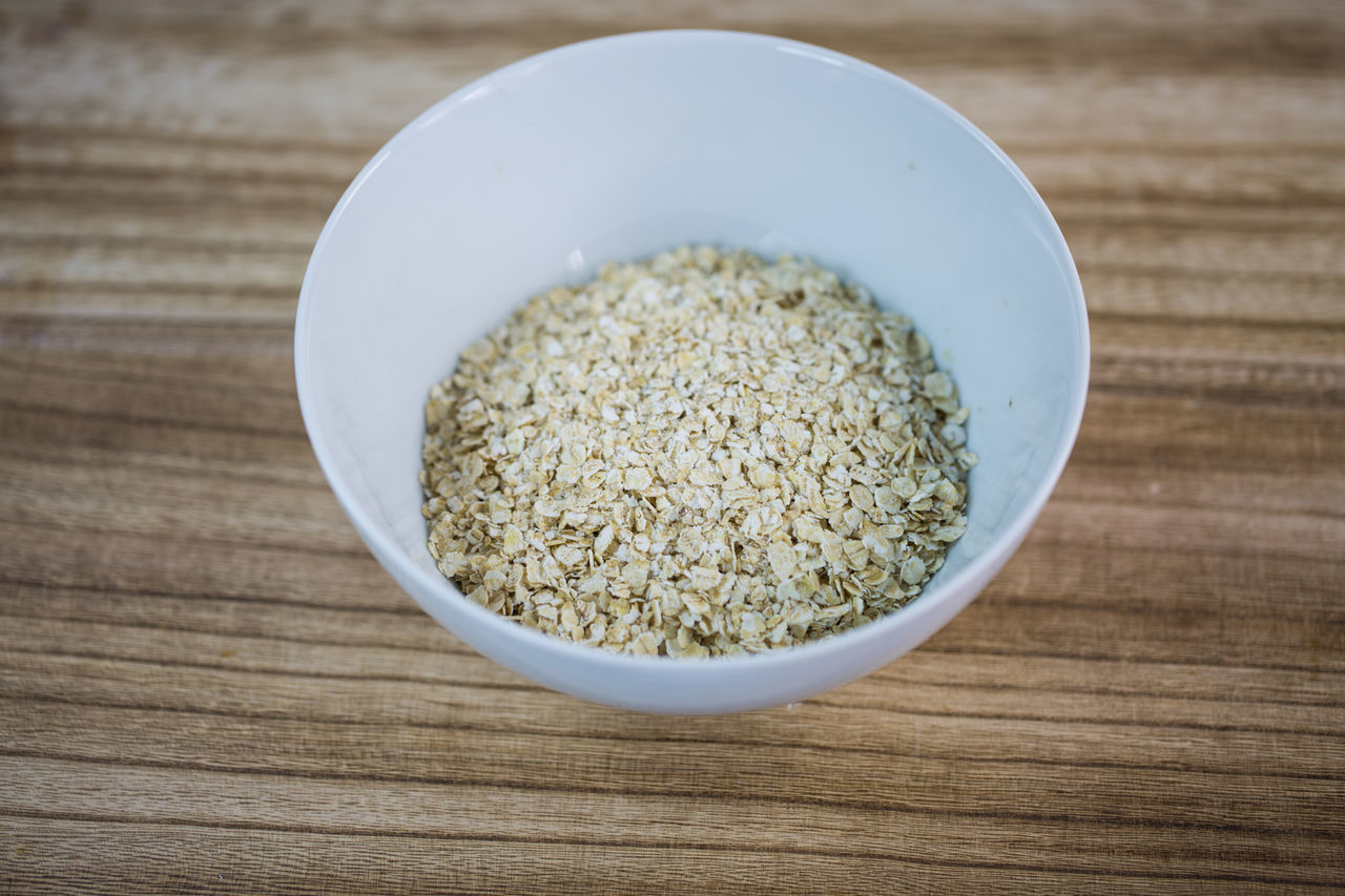 Oatmeal; organic; pile; oat; nutritious; isolated; natural; nutrition; piled; raw; vegetarian; white; whole; vegan; uncooked; rolled; texture; ingredient; heap; closeup; detail; diet; close; cereal; background; brown; dry; fiber; groats; health; healthy; 