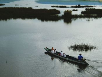 People in boat on lake