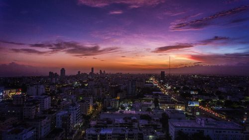 High angle view of illuminated buildings against sky at sunset