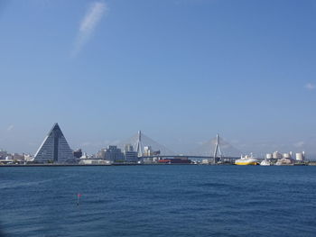 Sailboats in sea against clear blue sky