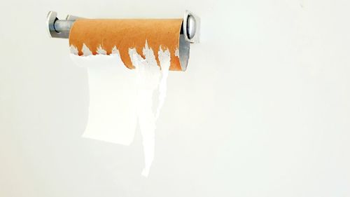 Close-up of text on paper against white wall