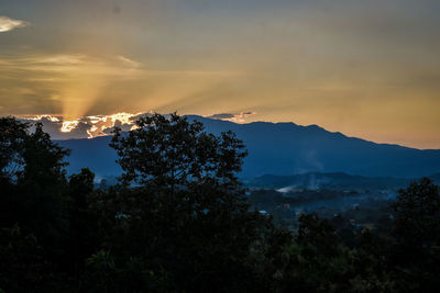 Scenic view of silhouette mountains against sky at sunset