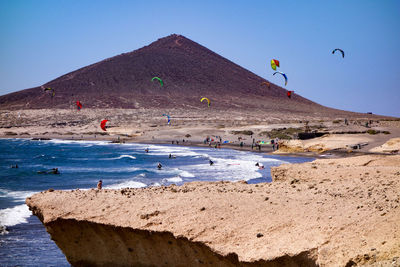 Scenic view of beach against clear blue sky