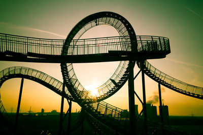 Low angle view of ferris wheel against sky