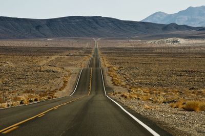 Highway amidst landscape against sky