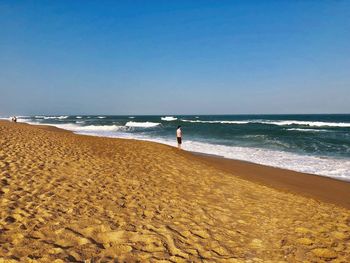 Man looking at view while standing at beach