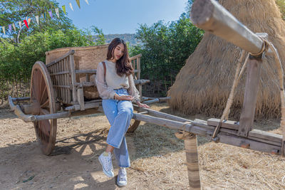 Woman holding umbrella while standing on land